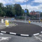 Half Battered (HB) RediKerb kerbing forming a curved traffic island at a junction, with keep-left bollards and segregated cycle route markings.