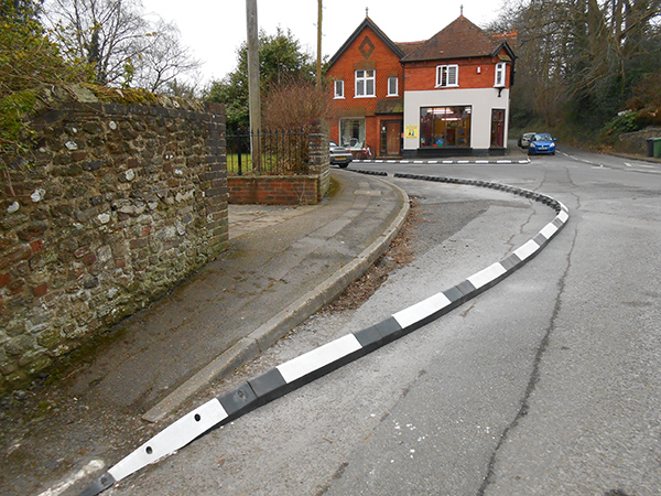 Splayed face (SP) RediKerb kerbing installed along a curved residential road junction.