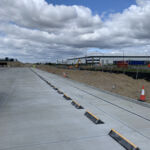 TruckStop 150 wheel stops installed in an industrial car park to prevent vehicle overrun.