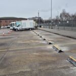 TruckStop 150 wheel stops installed in an industrial car park to prevent vehicle overrun.