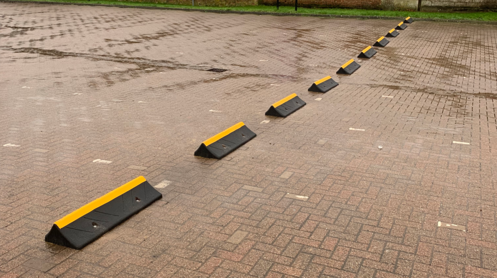 TruckStop 150 wheel stops installed in a car park to prevent vehicle overrun.