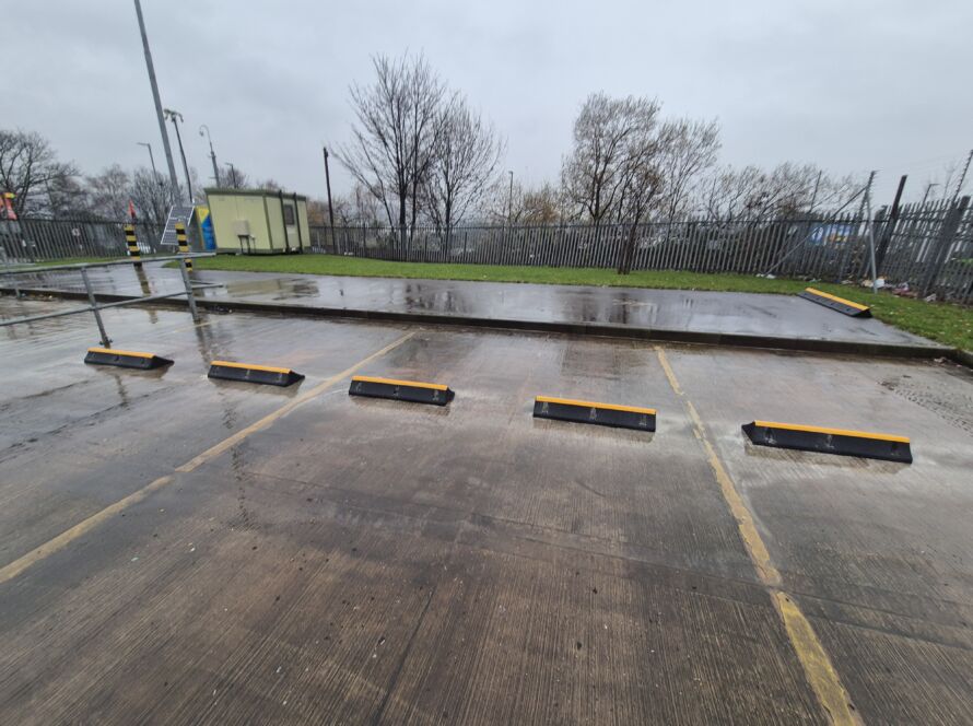TruckStop 150 wheel stops installed in an industrial car park to prevent vehicle overrun.