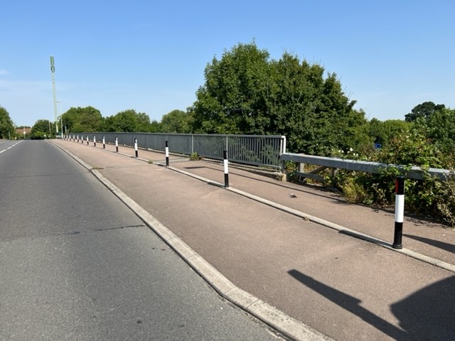 Verge markers installed along the edge of a rural road to delineate the shared footpath.