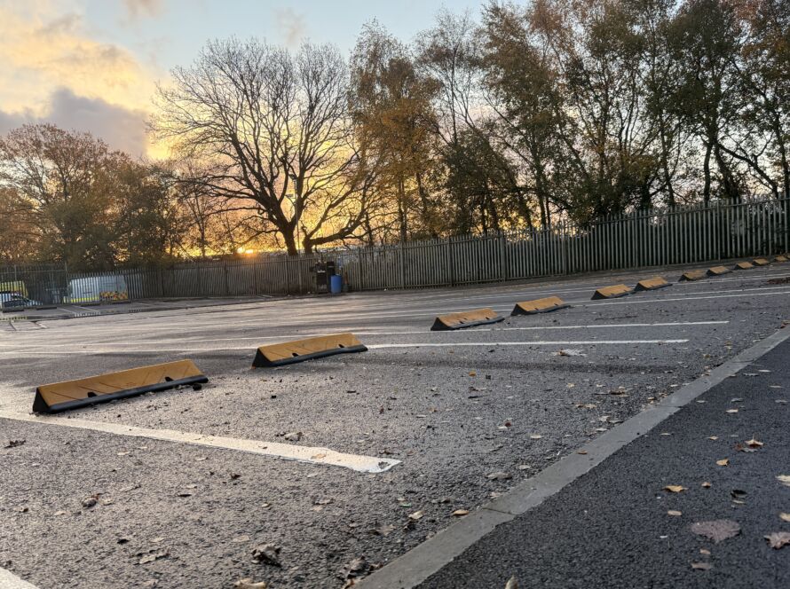 TruckStop 150 extended markings wheel stops installed in an industrial car park to prevent vehicle overrun.