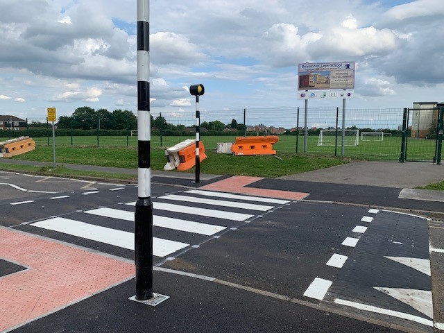 Infilled rubber combination table with zebra crossing and Belisha beacons installed on residential road