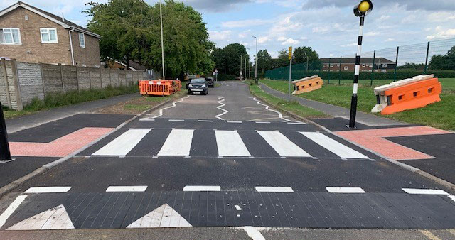 Finished infilled rubber combination table with zebra crossing and traffic calming layout on residential road.