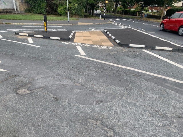 Wide view of junction with modular kerbing creating central refuge island and defined traffic flow.
