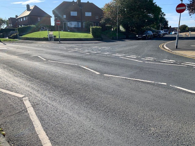 Pre-installation view of residential junction without kerbing or central traffic island.