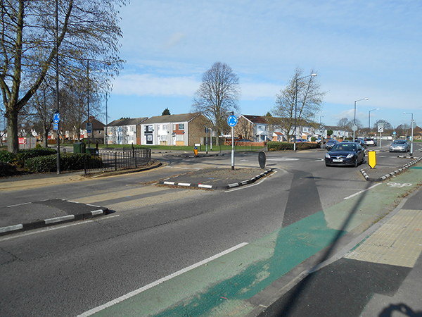 Black and white RediKerb traffic islands guiding vehicles and protecting cycle lane at busy junction.