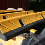 TruckStop 115 heavy-duty wheel stop with extended high-visibility markings installed to control vehicle stopping position.