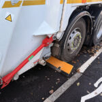 TruckStop 115 heavy-duty wheel stop with extended high-visibility markings installed to control vehicle stopping position.