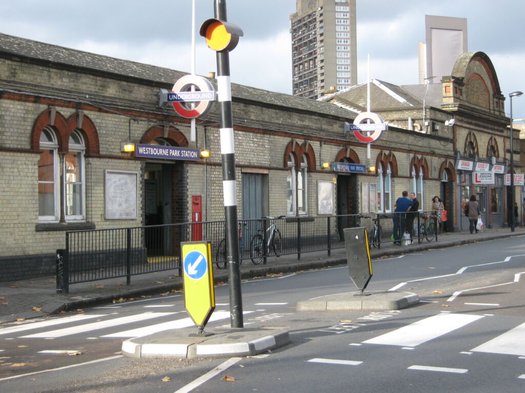 Close view of RediPave grey and white traffic island with illuminated bollard outside underground station