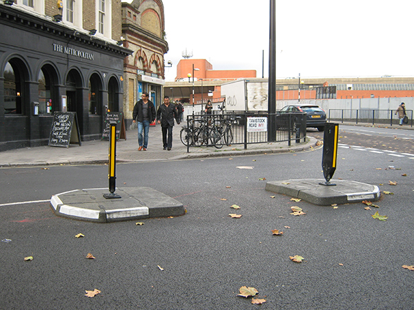 RediPave modular traffic islands with grey and white kerbing installed along city street for traffic calming.