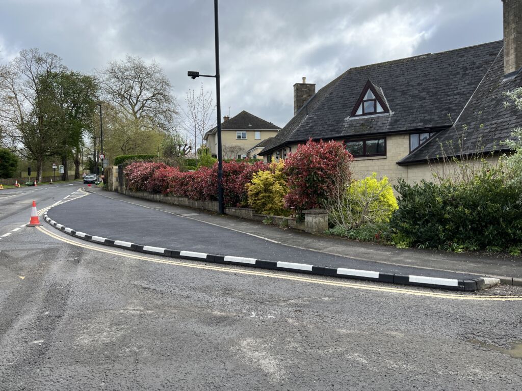 Newly installed black-and-white HB kerbing creates a clean, modern finish along this residential street in Bath, improving both road safety and visual appeal while blending seamlessly with the surrounding landscape.
